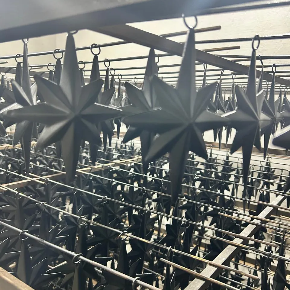 Star ornaments powder coated matte black, racked after curing